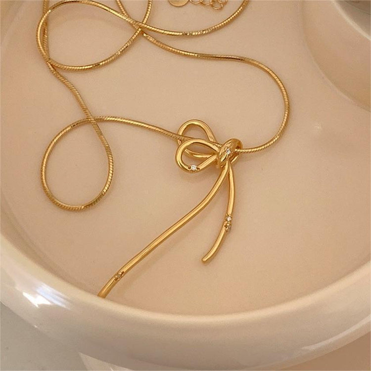 GOLD BOW NECKLACE